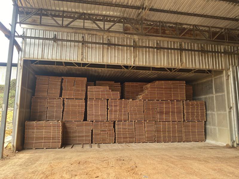 Stacks of kiln dried Iroko and Padauk timber in a warehouse