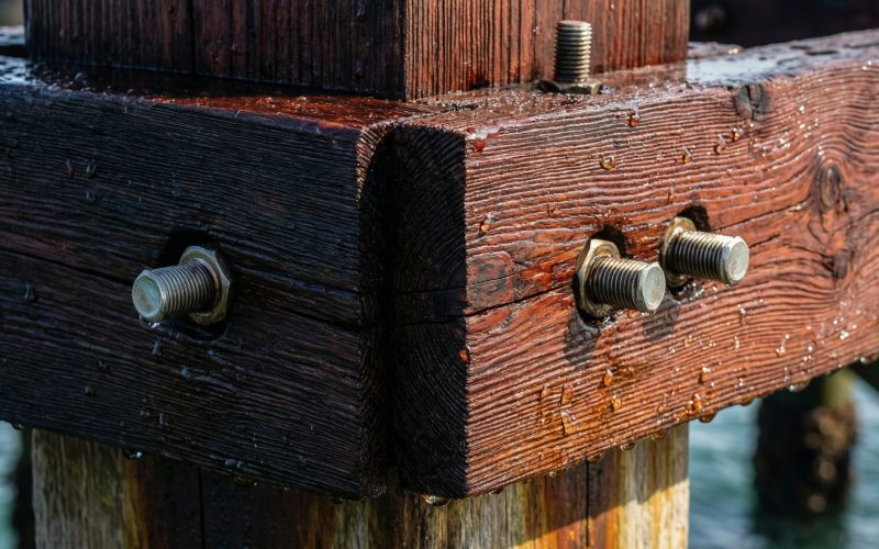 Engineers installing Azobé timber on coastal bridge structure