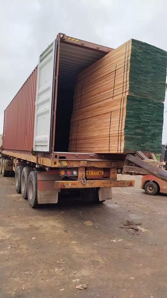 Okoume sawn timber being loaded into a shipping container